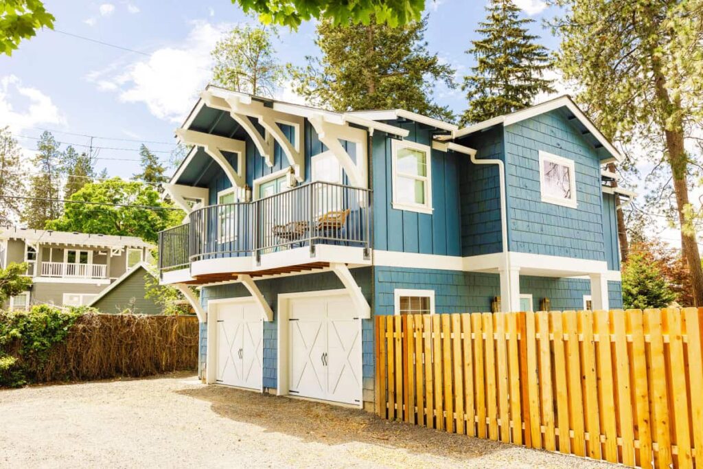 This High-End Residential Remodel by Schaff Homes Design-Build Contractor Spokane WA features a custom detached ADU with a two-car garage below and a private balcony above. Surrounded by mature trees and built for functionality and charm, this unit was inspected thoroughly before the client purchased the property, ensuring long-term value and code-compliant craftsmanship from the start.